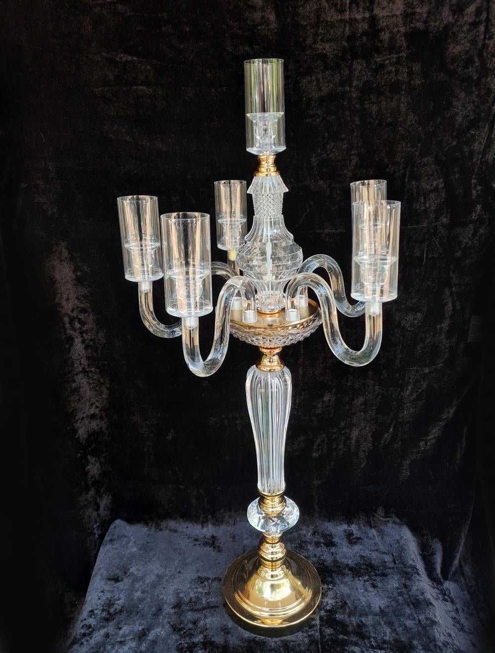 Six candles placed in a minimalist acrylic candle stand