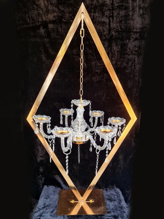 Six-arm candle chandelier mounted on a geometric diamond-shaped metal stand
