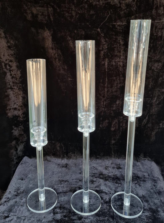 Set of three sleek clear stands designed for pillar candles